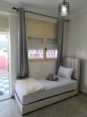 a bed with a stuffed animal on it in a room at City Center Apartment Fez in Fès