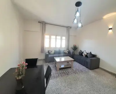 a living room with a couch and a table at City Center Apartment Fez in Fès