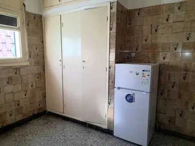 a kitchen with a white refrigerator and a window at City Center Apartment Fez in Fès