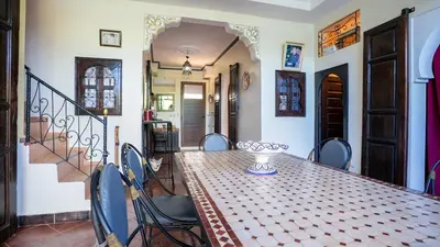 a dining room with a table and chairs at Villa Nafsi Aghmat Marrakech Piscine Chauffée in Aït Namous
