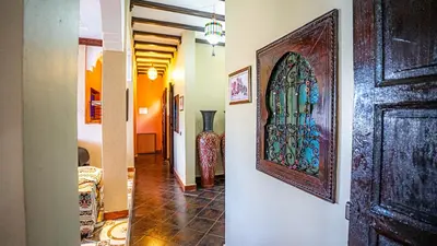 a hallway with a door with a stained glass window at Villa Nafsi Aghmat Marrakech Piscine Chauffée in Aït Namous