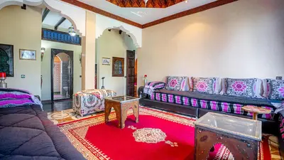a living room with a couch and a red rug at Villa Nafsi Aghmat Marrakech Piscine Chauffée in Aït Namous