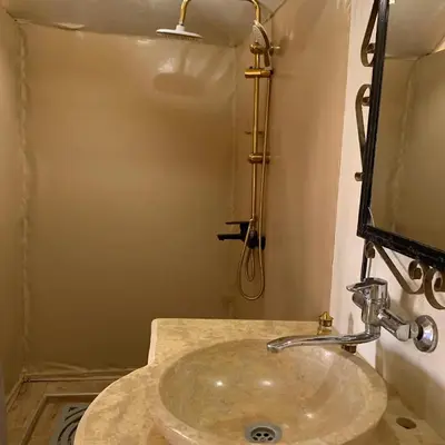 a bathroom with a sink and a mirror at Merzouga whisper camp in Merzouga