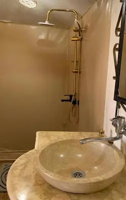 a sink in a bathroom with a shower at Merzouga whisper camp in Merzouga