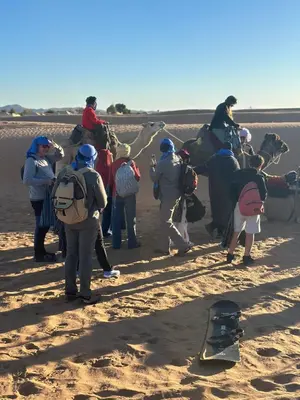 a group of people standing in the desert at Luxury camp in Hassilabied