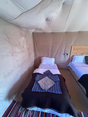 a bedroom with two beds in a tent at Luxury camp in Hassilabied