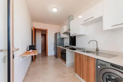 a kitchen with a sink and a dishwasher at Azur Apartment pool & design in Oulad Akkou