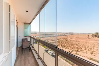 an office with a large window overlooking a field at Azur Apartment pool & design in Oulad Akkou