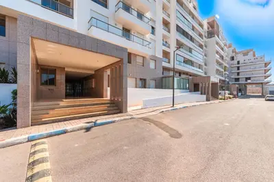 an empty street in front of a building at Azur Apartment pool & design in Oulad Akkou