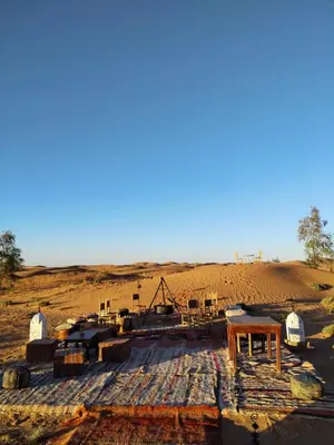a view of a desert with a mound of sand at LUNA LLENA Desert Camp Merzouga in Merzouga