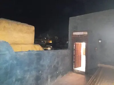 a room with a door on a building at night at IVANKA Guest House in Fès