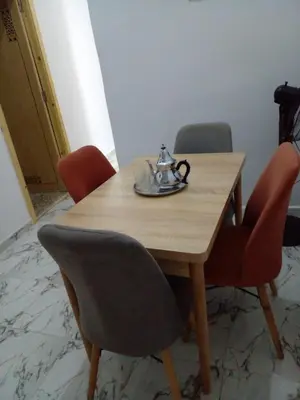 a wooden table with chairs and a tea kettle on it at Casa Miriam fes in Fès