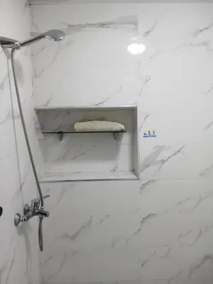a bathroom with a lamp and white marble walls at Casa Miriam fes in Fès