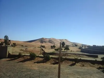 a view of a desert with a mountain in the background at Gite Omar merzouga in Merzouga