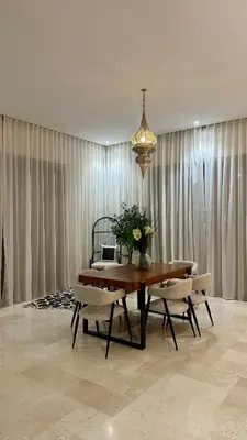 a dining room with a table and chairs and a chandelier at Exceptional Marrakech Villa 5 Bedrooms & Pool in Oulad Akkou