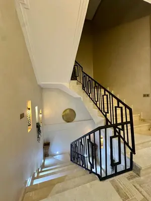 a staircase in a building with a spiral stair case at Exceptional Marrakech Villa 5 Bedrooms & Pool in Oulad Akkou