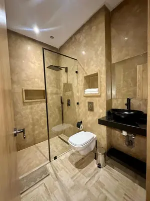 a bathroom with a shower and a toilet and a sink at Exceptional Marrakech Villa 5 Bedrooms & Pool in Oulad Akkou
