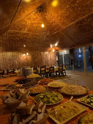 a table topped with lots of different types of food at Ksar merzouga luxury camp in Merzouga