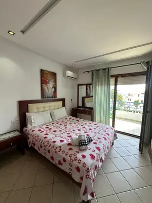 a bedroom with a large bed with a red blanket at BEST DREAM Spot in Oulad Akkou