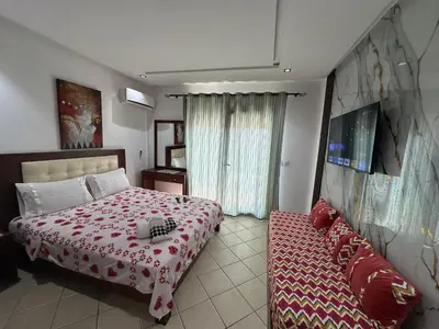 a bedroom with a bed and a couch at BEST DREAM Spot in Oulad Akkou