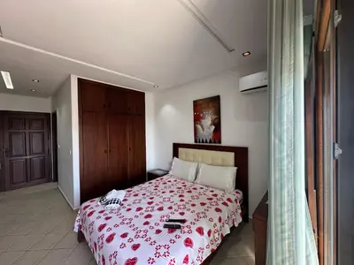 a bedroom with a bed with a red blanket at BEST DREAM Spot in Oulad Akkou