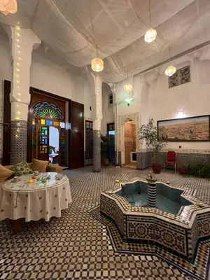 a lobby with a tub and a table in a room at Riad Dar Babouche in Fès