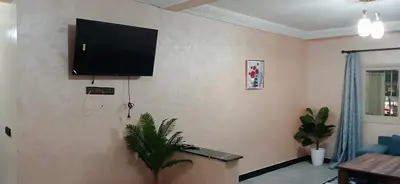 a living room with a flat screen tv on the wall at séjour à MARRAKECH in Oulad Akkou