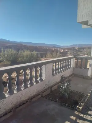 a stone railing on a balcony with a view at Berber Family
