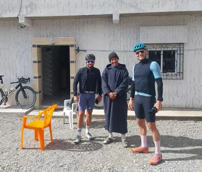 a group of three men standing in front of a building at Berber Family