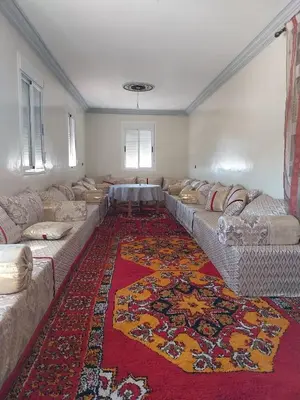 a large living room with couches and a rug at Berber Family