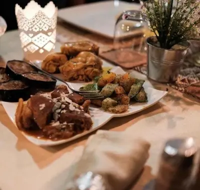 a table with two plates of food on it at Morocco luxury Camp in Merzouga