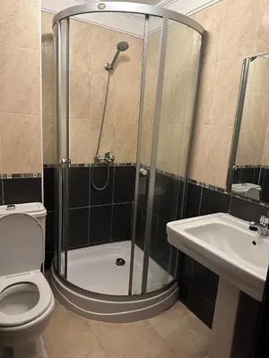 a shower in a bathroom with a toilet and a sink at 3 bedroom stunning flat Central Tanger Ville - Iberia in Oulad Akkou