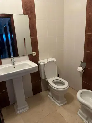 a bathroom with a toilet and a sink at 3 bedroom stunning flat Central Tanger Ville - Iberia in Oulad Akkou