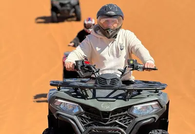 a man wearing a mask on a quad bike at Sahara Moon Luxury Camp in Merzouga