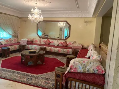 a living room with a couch and a mirror at Tessas Crib in Fès
