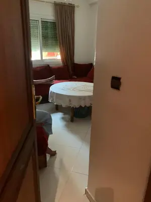 a living room with a table and a couch at Tessas Crib in Fès