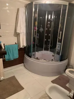 a bathroom with a shower with a toilet and a sink at Tessas Crib in Fès