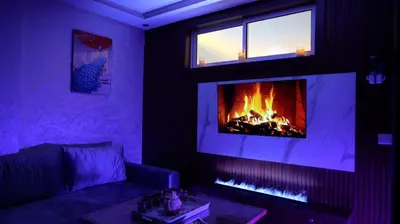a living room with a couch and a fireplace at APPARTEMENT AMJAD iFRANE in Ifrane