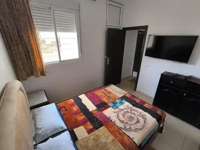 a bedroom with a bed with a quilt on it at Le séjour agréable in Ifrane