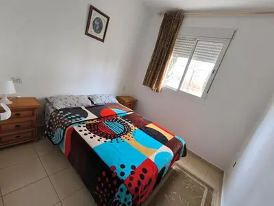a bedroom with a bed with a colorful comforter at Le séjour agréable in Ifrane