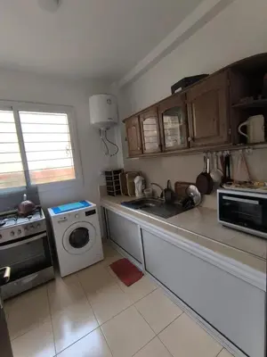 a kitchen with a washing machine and a washer at Le séjour agréable in Ifrane
