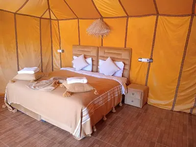 a bedroom with a bed in a tent at Dune's treasure, luxury camp in Merzouga