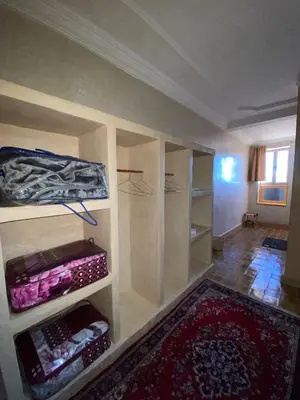 a room with a room with shelves and a rug at Auberge Soleil Bleu in Boumalne