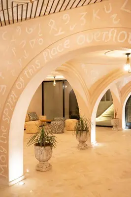 a large room with arches and plants in it at Nasser Palace Suites & Spa in Hassilabied