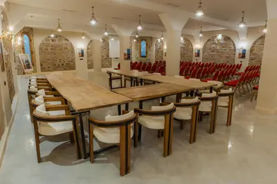 a large dining room with wooden tables and chairs at Nasser Palace Suites & Spa in Hassilabied