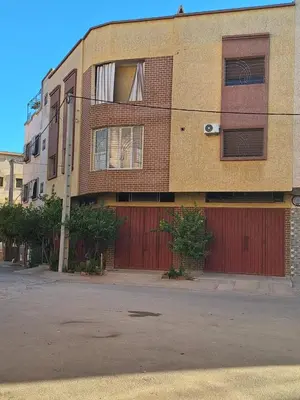 an apartment building with red doors and a fence at appartement chic, calme et bien équipé in Meknès