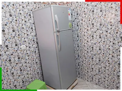 a refrigerator in the corner of a room at Appartement familial en sous-sol près des chutes d'Ouzoud, confortable et sûr in Azilal