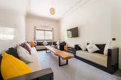 a living room with couches and a coffee table at Charming Flat with AC Fast Wifi Secure Residence in Oulad Akkou