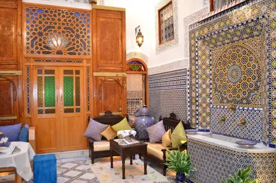 a living room with a tub and a couch at Riad Dar Salma in Fès