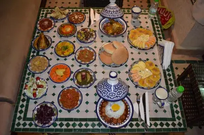 a table topped with plates of food on a table at Riad Dar Salma in Fès